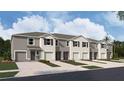 New townhome with neutral exterior, landscaping, and single-car garage at 31326 Ancient Sage Rd, Wesley Chapel, FL 33545