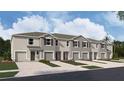 New townhome with neutral exterior, landscaping, and single-car garage at 31326 Ancient Sage Rd, Wesley Chapel, FL 33545