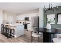 Modern kitchen with stainless steel appliances, a center island, and a stylish dining area at 37255 Sagemoor Dr, Zephyrhills, FL 33541