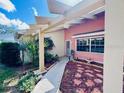 Exterior view of a home's front entrance, featuring a decorative walkway and a covered entryway at 3845 Edgemont Dr, New Port Richey, FL 34652