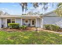 Inviting single-story home featuring a well-maintained lawn and beautiful landscaping at 39650 Us Highway 19 N # 553, Tarpon Springs, FL 34689