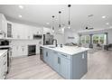 Open kitchen with white and gray cabinets, island seating, stainless steel appliances, and wine cooler at 4120 W North A St # 2, Tampa, FL 33609