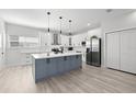 Stylish kitchen with a gray island, white cabinets, stainless steel appliances and modern lighting at 4120 W North A St # 2, Tampa, FL 33609