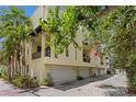 Rear exterior showcasing the building's architecture, including garage access and private balconies for each unit at 512 S Glen Ave, Tampa, FL 33609