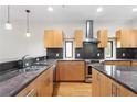 Well-equipped kitchen boasts stainless steel appliances, granite countertops, wood cabinetry, and ample counter space at 512 S Glen Ave, Tampa, FL 33609
