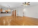 Open-concept living space features hardwood floors, modern lighting, and seamless flow into the adjacent kitchen at 512 S Glen Ave, Tampa, FL 33609