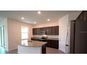 Modern kitchen featuring stainless steel appliances and a granite island at 5407 Kedgewick Ln, North Port, FL 34288