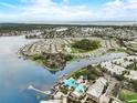 Panoramic aerial view showcasing waterfront homes, a community pool, and stunning water views at 5413 Wishing Arch Dr, Apollo Beach, FL 33572