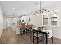 Open kitchen featuring white cabinetry, stainless steel appliances, and granite countertops at 5613 Kingsley Corner Way, Lithia, FL 33547