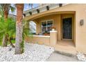 A welcoming front porch with white rocks, palm trees, flowers, and a decorated front door at 7705 S Sparkman St, Tampa, FL 33616
