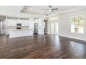 Spacious living room with hardwood floors, high ceilings, and lots of natural light at 9416 Bullfrog Court, Gibsonton, FL 33534