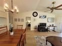 View of dining room adjacent to living area and kitchen, with light hardwood floors at 946 Madrid Dr, Palm Harbor, FL 34684