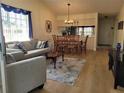 Open-concept living and dining area with wood floors and lots of natural light at 946 Madrid Dr, Palm Harbor, FL 34684