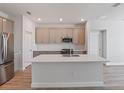Spacious open kitchen with stainless steel appliances, center island, and modern cabinetry at 9989 Surrey Rose Dr, San Antonio, FL 33576
