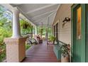 Spacious front porch ideal for outdoor living, with seating and charming details at 1001 E Crawford St, Tampa, FL 33604