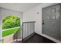Exterior entrance to unit with stairs and a secure door at 1170 Pine Ridge W Cir # C2, Tarpon Springs, FL 34688