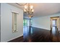 View of the open-concept living room featuring hardwood floors, a ceiling fan, and plenty of natural light at 1170 Pine Ridge W Cir # C2, Tarpon Springs, FL 34688