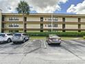 Image shows parking for the units with landscaping at 14130 Rosemary Ln # 3215, Largo, FL 33774