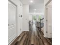 Hallway with hardwood floors leading to the living and dining areas, and the stairs at 14282 Coronado Dr, Spring Hill, FL 34609