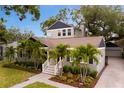 Stunning angle of the home with meticulous landscaping, lush green lawn, and a brick-paved driveway at 2933 W Alline Ave, Tampa, FL 33611