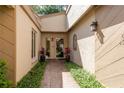 Inviting front entrance featuring mature landscaping and neutral paint scheme at 3071 Bolt Dr, Palm Harbor, FL 34685