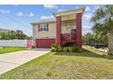 Beautiful home featuring a unique design with lush landscaping and a vibrant color scheme at 3227 Rose Arbor Dr, Hernando Beach, FL 34607