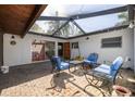Covered brick patio featuring stylish outdoor furniture, creating a cozy and inviting outdoor living space at 328 Tallahassee Ne Dr, St Petersburg, FL 33702
