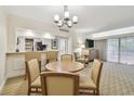 Inviting living area with a dining table, bar seating, and modern lighting fixtures at 36750 Us 19 N # 07208, Palm Harbor, FL 34684