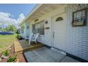 Inviting front porch with seating area, perfect for enjoying the outdoors at 402 12Th Sw St, Ruskin, FL 33570
