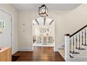 Bright foyer with hardwood floors, staircase, and arched entryway to the dining room at 455 18Th Ne Ave, St Petersburg, FL 33704