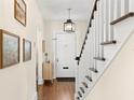 Bright foyer features hardwood floors, staircase, and transom windowed front door at 455 18Th Ne Ave, St Petersburg, FL 33704