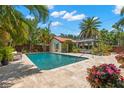 Backyard oasis with a sparkling pool, cabana, and tropical landscaping at 455 18Th Ne Ave, St Petersburg, FL 33704