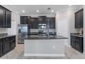 Modern kitchen featuring stainless steel appliances, granite countertops, and a center island at 4690 Coachford Dr, Wesley Chapel, FL 33543