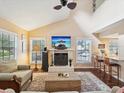 Bright living room with fireplace, hardwood floors, and open floor plan to the kitchen at 5729 Calais N Blvd # 6, St Petersburg, FL 33714