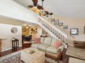 Cozy living room with hardwood floors, staircase, and adjacent dining area at 5729 Calais N Blvd # 6, St Petersburg, FL 33714
