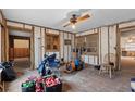 Spacious living area with wood-look floors, ceiling fan, and natural light from windows at 701 59Th Ne Ave, St Petersburg, FL 33703