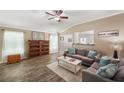 Comfortable living room boasting wood floors, a neutral color palette, and a ceiling fan for added comfort at 7103 Bridgeview Dr, Wesley Chapel, FL 33545