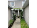 Covered entrance welcomes you with climbing vines and lush shrubbery at this charming townhome at 7838 66Th N Way, Pinellas Park, FL 33781