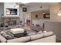 A cozy living room featuring a stone fireplace, neutral furniture, and an open layout, perfect for relaxation and entertaining at 80 Sycamore Ct, Palm Harbor, FL 34683