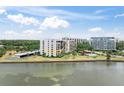 Waterfront condo building with lush landscaping and gorgeous water views, offering a serene and luxurious living environment at 100 Oakmont Ln # 310, Belleair, FL 33756
