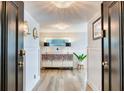 Inviting hallway featuring wood-look flooring, stylish decor, and elegant lighting fixtures at 100 Oakmont Ln # 310, Belleair, FL 33756