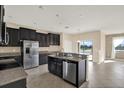 Modern kitchen featuring stainless steel appliances, granite countertops, and dark cabinetry at 10106 Count Fleet Dr, Ruskin, FL 33575