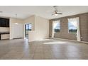 Open-concept living space featuring tile flooring, a ceiling fan, and access to the patio at 10106 Count Fleet Dr, Ruskin, FL 33575