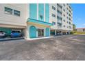 Charming building entrance with blue accents and covered parking for convenience at 10216 Regal Dr # 208, Largo, FL 33774