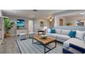 Bright living room featuring contemporary decor, stylish furniture, and wood-look flooring at 11188 64Th Ter, Seminole, FL 33772