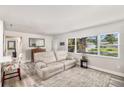 Bright living room with large window and comfortable seating, offering a relaxing space for entertaining at 1530 Picardy Cir, Clearwater, FL 33755
