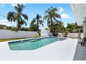 Private pool with a lounge chair surrounded by tropical plants at 1530 Picardy Cir, Clearwater, FL 33755