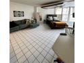Open concept living and bedroom space has tile floors, large windows, and surfboard decoration on the ceiling at 16400 Gulf Blvd # 307, North Redington Beach, FL 33708