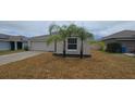 Charming single-story home featuring an attached two-car garage and well-maintained landscaping at 2216 4Th Sw St, Ruskin, FL 33570