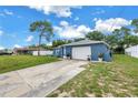 A quaint one-story home with a front lawn and a driveway leading to an attached garage at 2270 Amherst Ave, Spring Hill, FL 34609